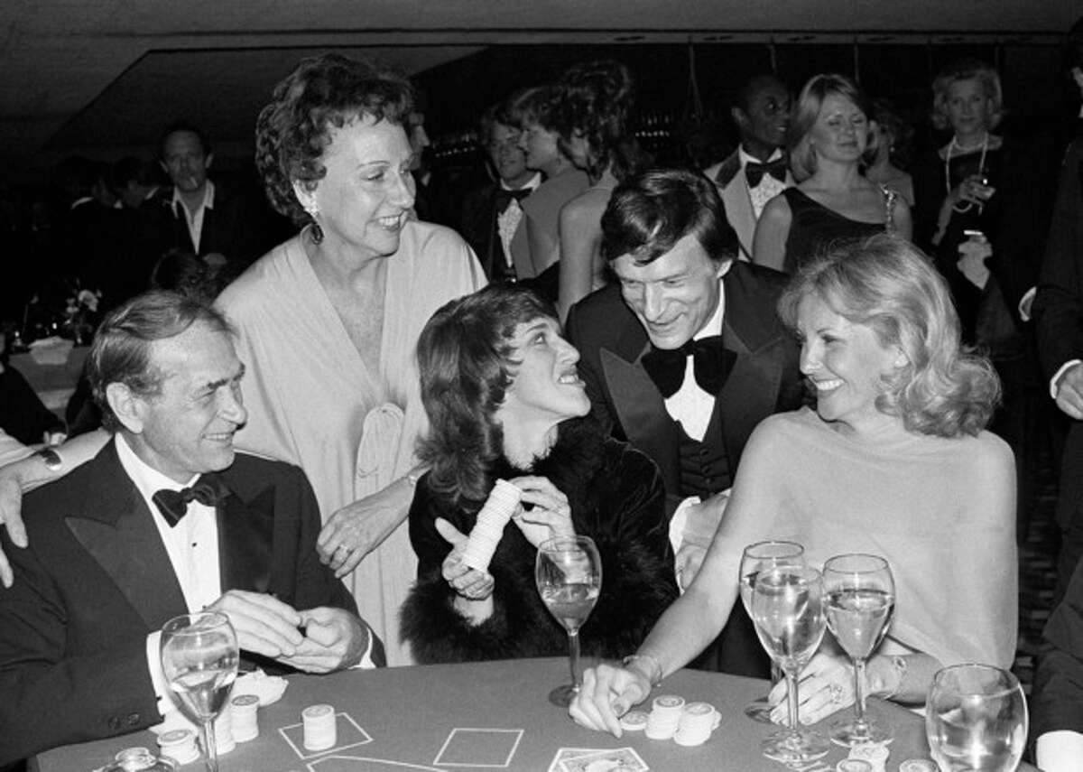 Actress Jean Stapleton, top left, and publisher Hugh Hefner laugh with, from foreground left, Darren McGavin, Ruth Buzzi and Barbara Fisher, during a black-tie casino fund raiser in Los Angeles on Monday, March 13, 1979. Stapleton has died at the age of 90. John Putch said Saturday, June 1, 2013 that his mother died Friday, May 31, 2013 of natural causes at her New York City home surrounded by friends and family. (AP Photo/Lennox McLendon)