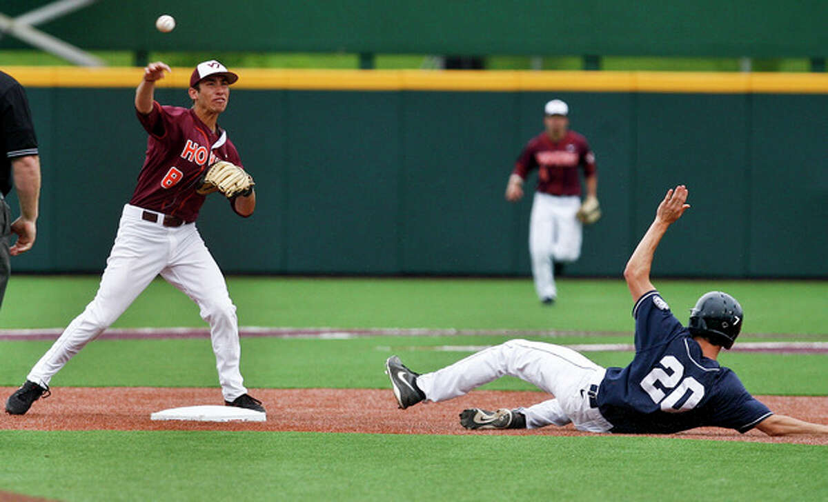 Virginia Tech's Alex Perez, left, steps on second to put out Connecticut's Ryan Moore (20) and fires to first to complete a double play during the ninth inning of an NCAA college baseball tournament regional game at English Field in Blacksburg, Va., Sunday, June 2, 2013. (AP Photo/Michael Shroyer)