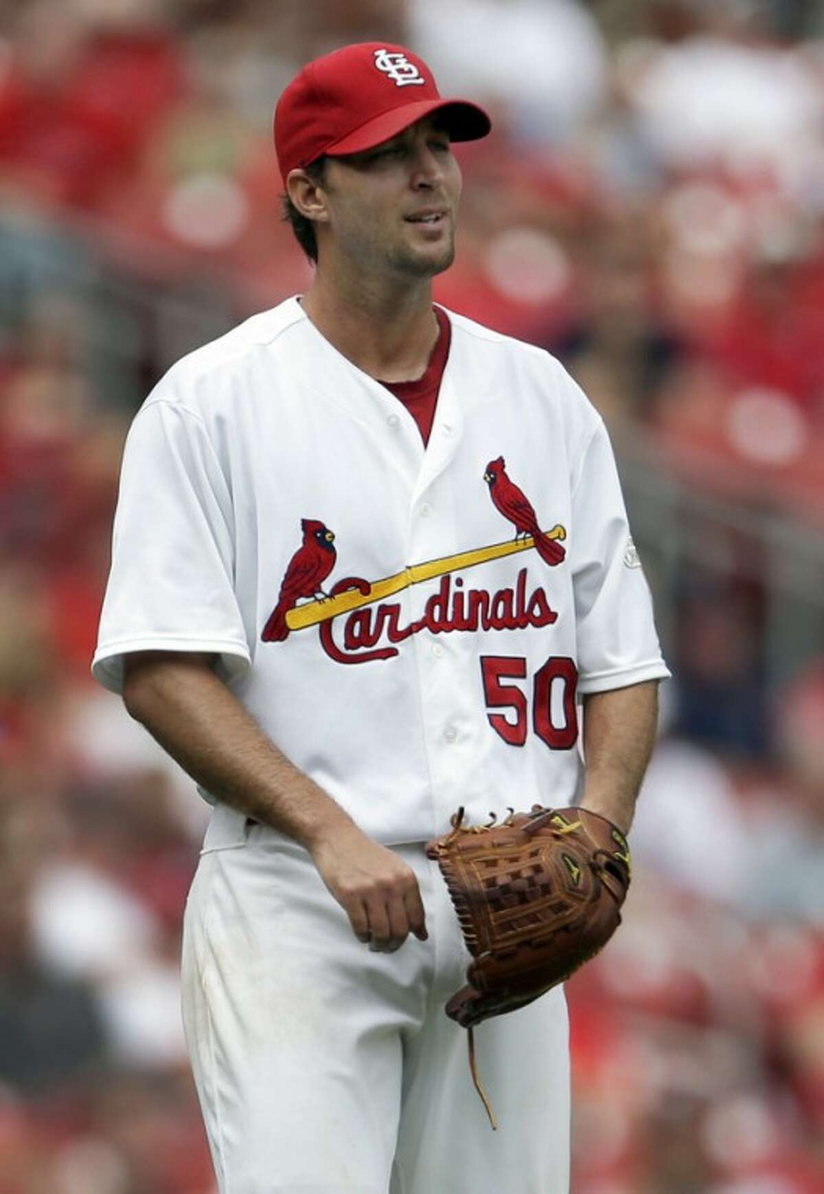 St. Louis Cardinals starting pitcher Adam Wainwright watches as a ball hit for a three-run home run by New York Mets' Ike Davis leaves the park during the fifth inning of a baseball game Wednesday, Sept. 5, 2012, in St. Louis. (AP Photo/Jeff Roberson)