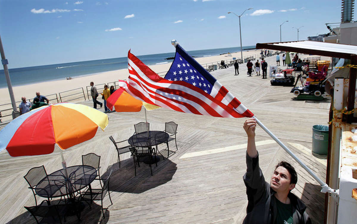 Thomas Bodary, of Spring Lake, prepares to open Mayfair Boardwalk Grill on the boardwalk in Asbury Park, N.J., Sunday, May 26, 2013. The first summer season after Superstorm Sandy is underway at the Jersey shore, parts of which were devastated by the October storm. This is a brand-new Jersey Shore. While some recovery is still ongoing from Superstorm Sandy, the Jersey Shore to a very large extent has been cleaned up, rebuilt, reopened and is ready for business. (AP Photo/Mel Evans)