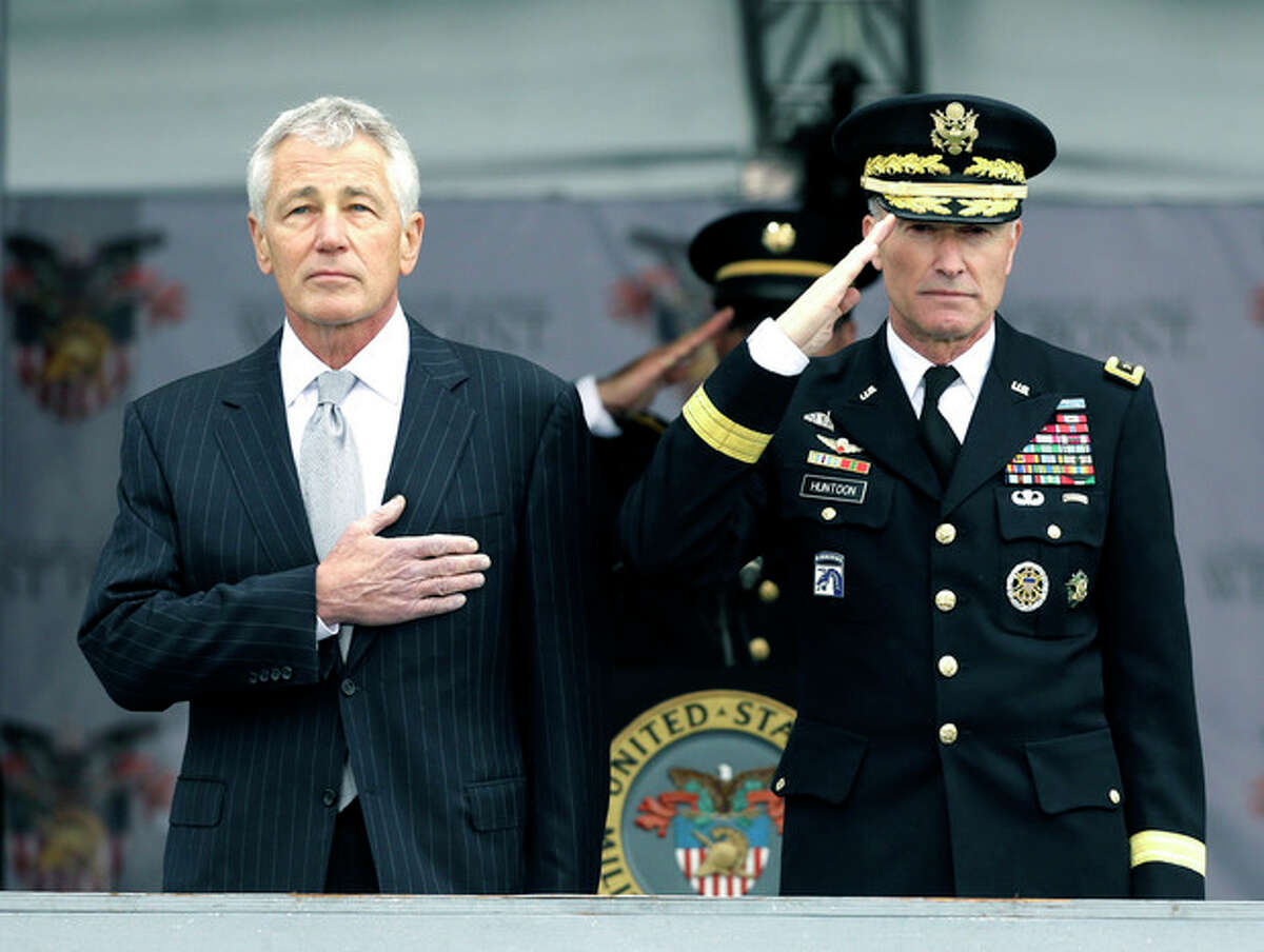 Defense Secretary Chuck Hagel, left, and Superintendent Lt. Gen. David Huntoon, Jr., stand for the national anthem during a graduation and commissioning ceremony at the U.S. Military Academy in West Point, N.Y. on Saturday, May 25, 2013. (AP Photo/Mike Groll)