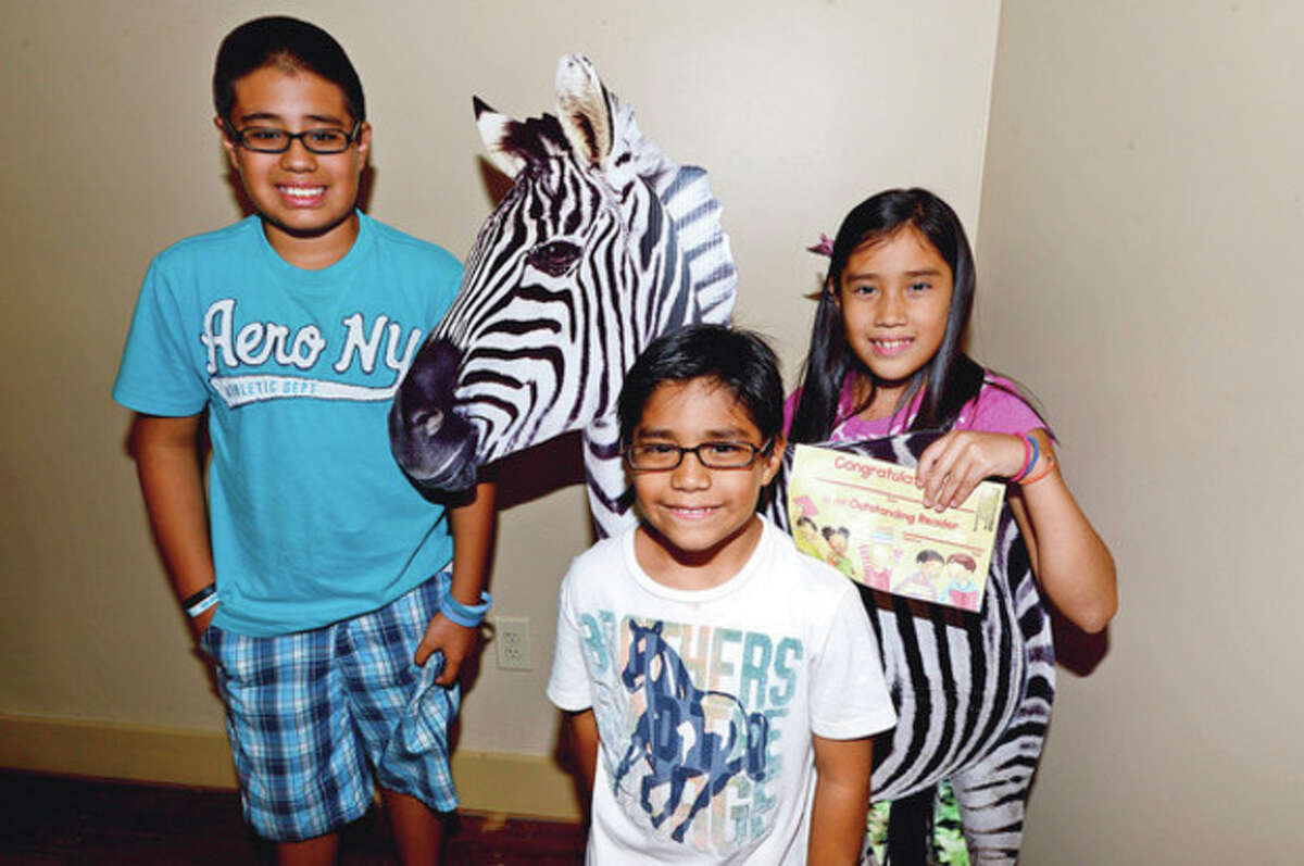 Kevin, Kelsey and Axel Nava were recognized at The Summer Reading Certificate Ceremony and Back to School Kickoff celebration for children who completed the "Summer Safari" summer reading program at the Stew Leonard III Children's Library of the South Norwalk Branch Saturday. photo / Erik Trautmann