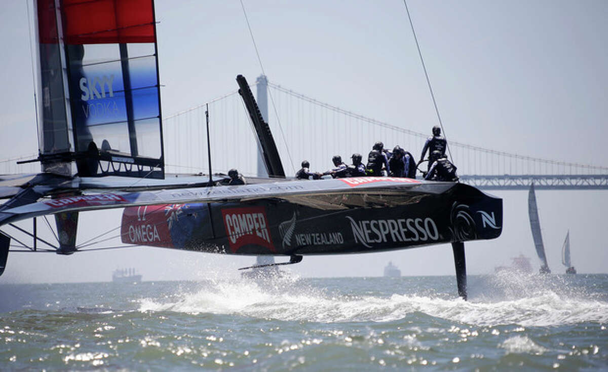 Emirates Team New Zealand train for the America's Cup with the San Francisco-Oakland Bay Bridge in the background Friday, May 24, 2013 in San Francisco. (AP Photo/Eric Risberg)