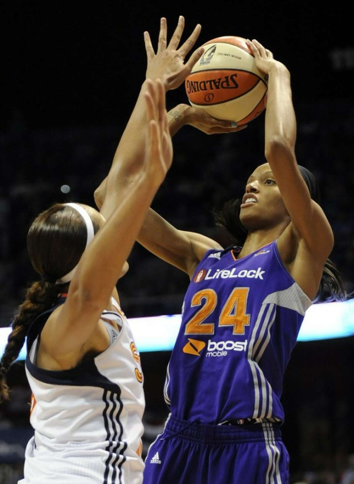 Phoenix Mercury's DeWanna Bonner (24) shoots over Connecticut Sun's Mistie Mims in the second half of a WNBA basketball game in Uncasville, Conn., Friday, Sept. 7, 2012. Bonner was top scorer for Phoenix with 35 points as Phoenix topped Connecticut 91-82. (AP Photo/Jessica Hill)