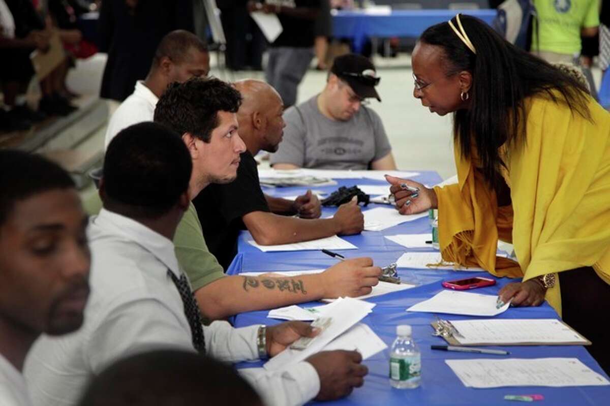 FILE - In this Tuesday, Aug. 21, 2012 file photo, job seekers fill out applications at a construction job fair in New York. U.S. employers added 96,000 jobs last month, the Labor Department said Friday, Sept. 7, 2012, a weak figure that could slow any momentum President Barack Obama hoped to gain from his speech to the Democratic National Convention. (AP Photo/Seth Wenig, File)