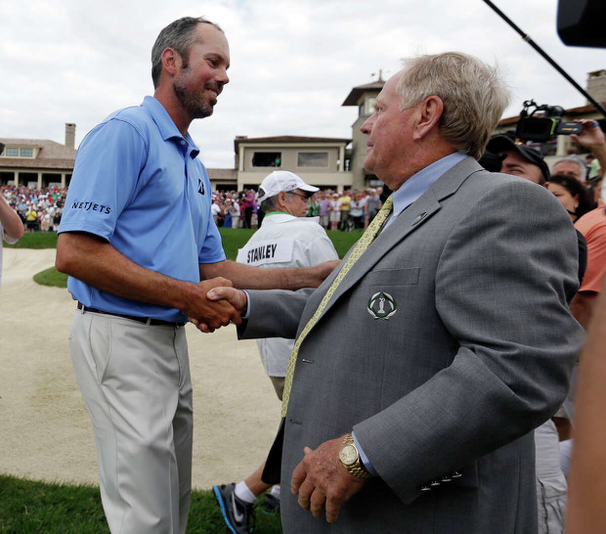 Matt Kuchar, left, is congratulated by Jack Nicklaus after winning the Memorial golf tournament on Sunday, June 2, 2013, in Dublin, Ohio. (AP Photo/Darron Cummings)