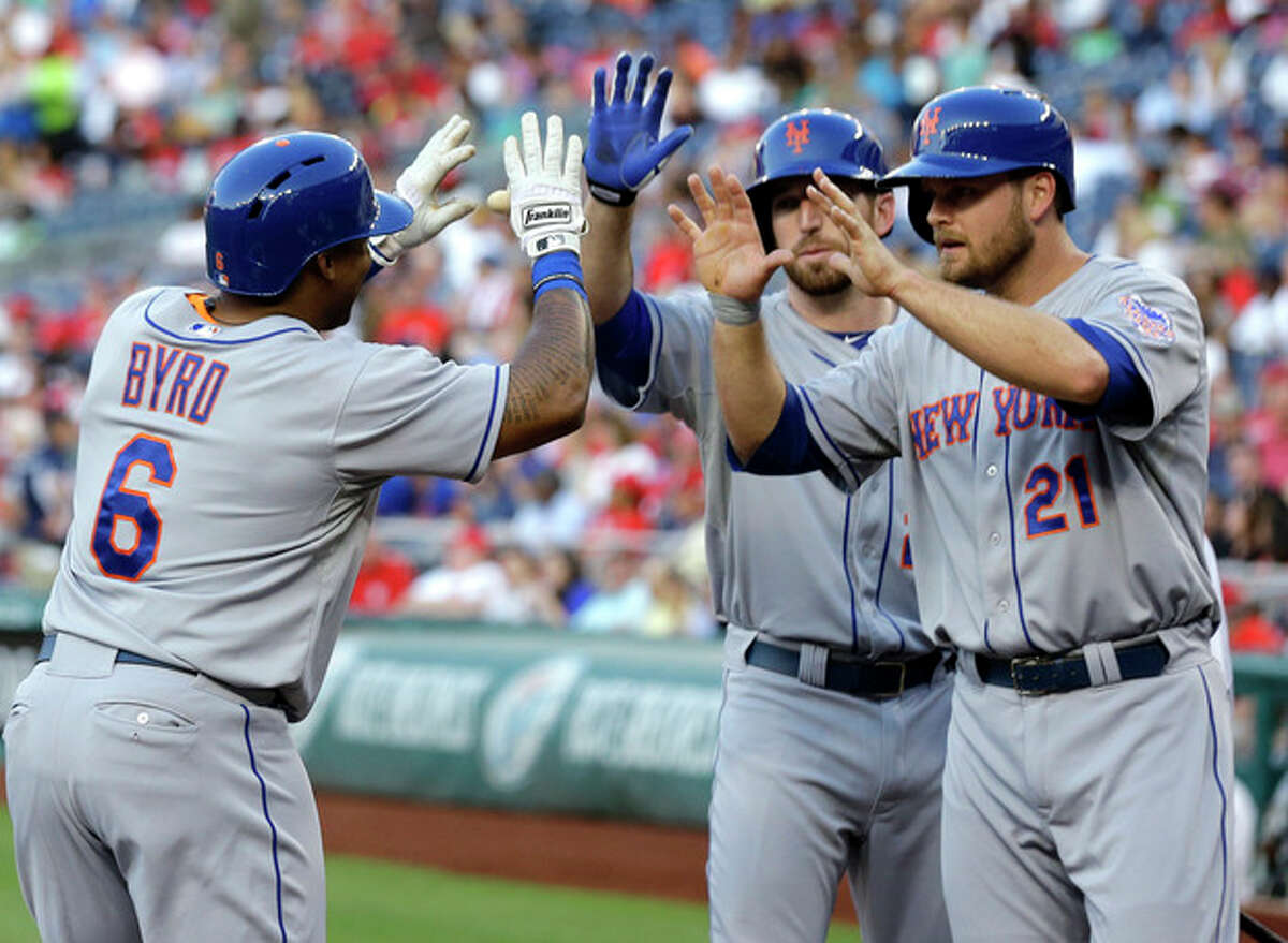 New York Mets' Marlon Byrd (6) celebrates with Ike Davis (29) and Lucas Duda (21) after Byrd's two-run home run during the second inning of a baseball game against the Washington Nationals at Nationals Park on Wednesday, June 5, 2013, in Washington. (AP Photo/Alex Brandon)