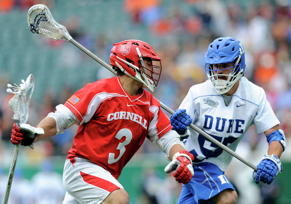 Cornell's Rob Pannell (3) drives past Duke's Bill Conners (55) during the first half of an NCAA division 1 semifinal lacrosse game on Saturday, May 25, 2013, in Philadelphia. (AP Photo/Michael Perez)