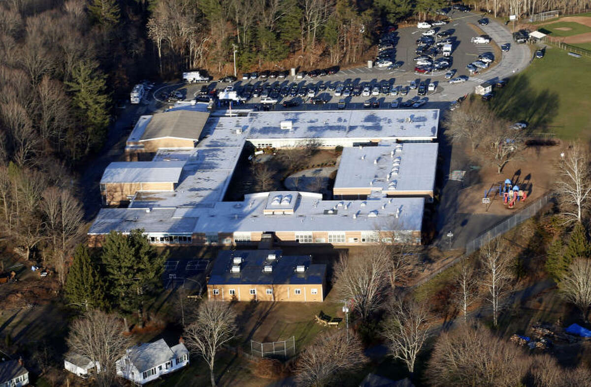 FILE - This Dec. 14, 2012 aerial file photo shows Sandy Hook Elementary School in Newtown, Conn., where a gunman shot 27 people dead, including 20 children. The Sandy Hook School Building Task Force meets Friday night, May 3, 2013, to debate whether to renovate or rebuild on the existing school site, or to construct a new school building on nearby property. (AP Photo/Julio Cortez, File)
