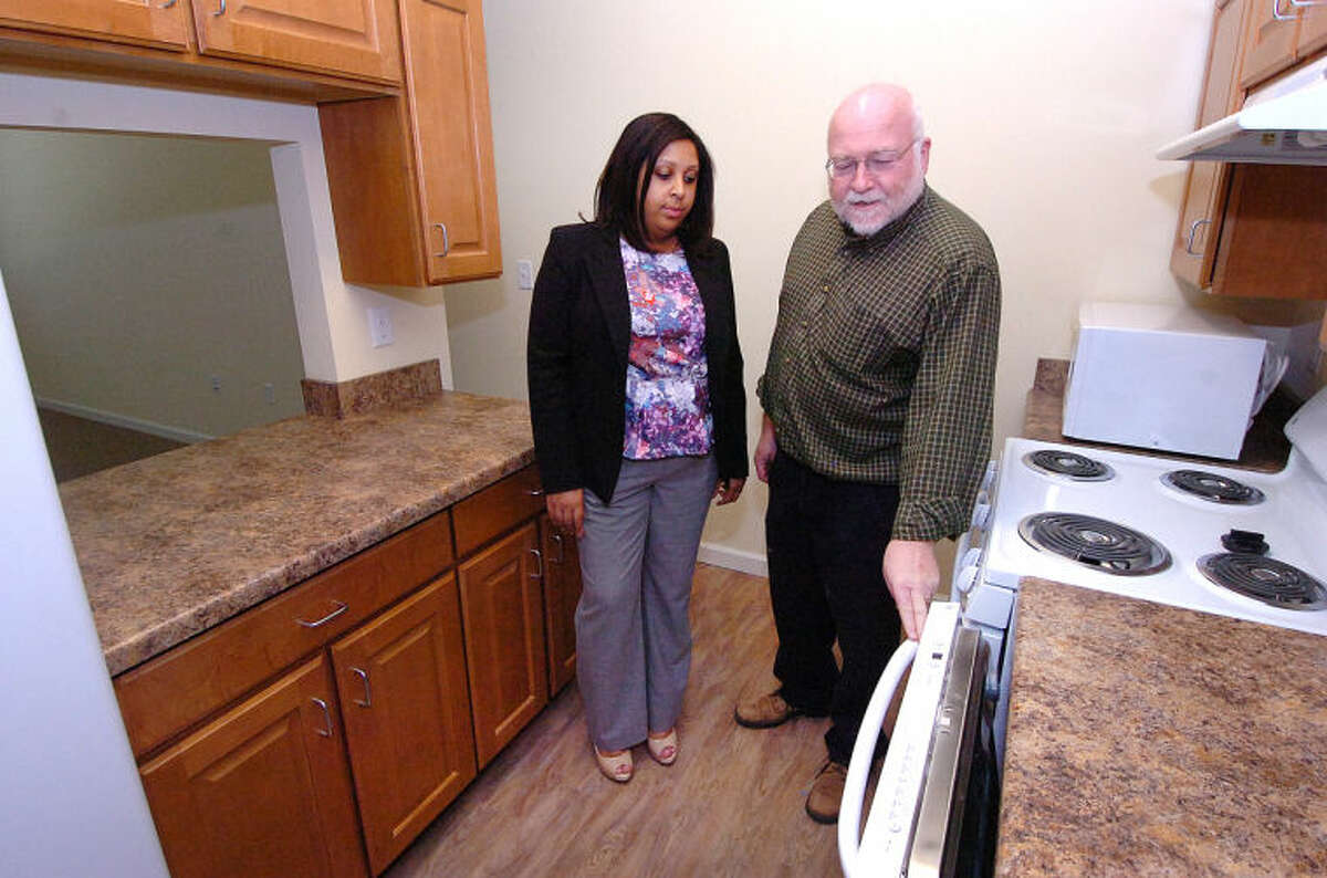 Hour Photo/Alex von Kleydorff . Director of Housing Development Keith Cryan and Property Manager Johneisha DuBose walk through the kitchen in a one bedroom unit at Wilton Commons