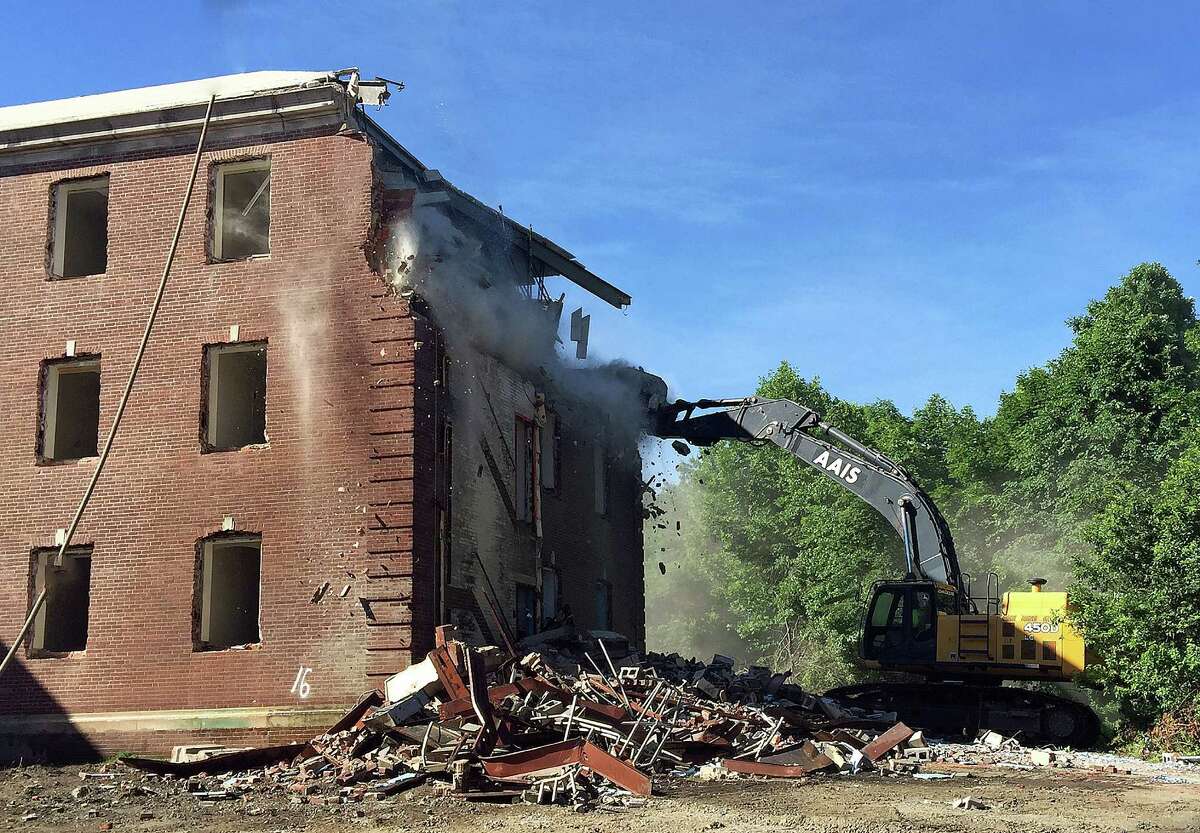 Demolition of a former Fairfield Hills Hospital administration building began Wednesday at Newtown’s municipal campus.
