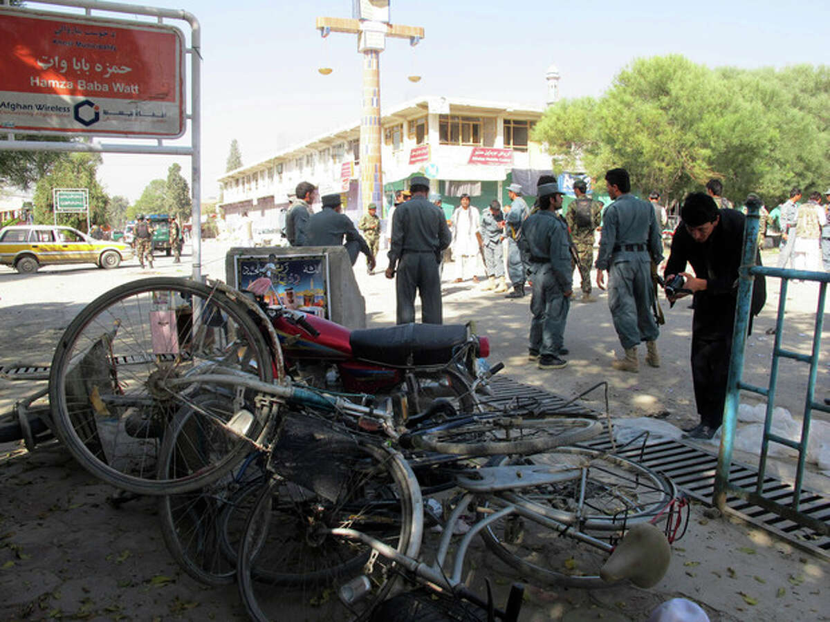 Afghan police secure the site of a suicide bombing in Khost, south of Kabul, Afghanistan, Monday, Oct. 1, 2012. The suicide bomber was driving a motorcycle packed with explosives and rammed it into a patrol of Afghan and international forces, killing over a dozen people, including three NATO service members and their translator, official said. (AP Photo/Nashanuddin Khan)