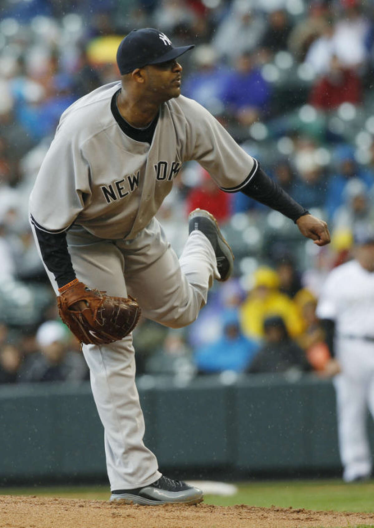 New York Yankees starting pitcher CC Sabathia works against the Colorado Rockies in the first inning of a baseball game in Denver on Thursday, May 9, 2013. (AP Photo/David Zalubowski)