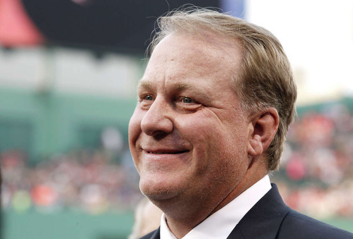 FILE - This Aug. 3, 2012 file photo shows former Boston Red Sox pitcher Curt Schilling smiling after being introduced as a new member of the Boston Red Sox Hall of Fame before the baseball game between the Boston Red Sox and the Minnesota Twins at Fenway Park in Boston. Schilling might have to sell the famed blood-stained sock he wore during the 2004 World Series to cover millions of dollars in loans he guaranteed to his failed video game company. Schilling, whose Providence-based 38 Studios filed for bankruptcy in June, listed the sock as collateral to a bank in a September filing with the Massachusetts Secretary of State. (AP Photo/Winslow Townson, File)