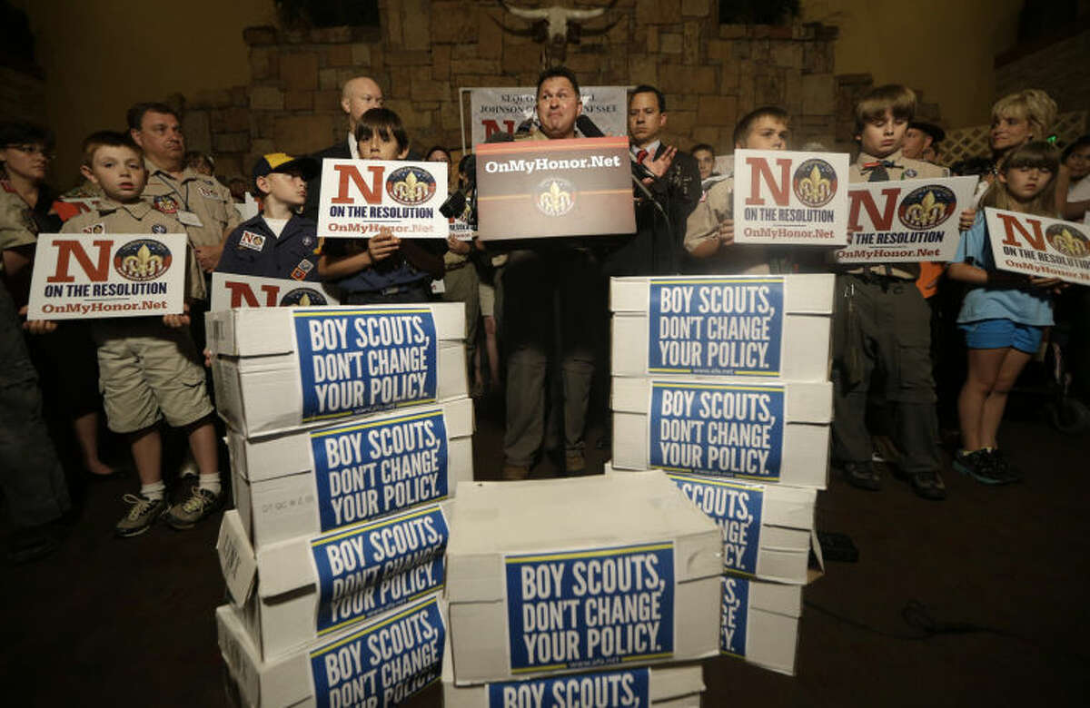John Stemberger, center, leads a press conference backed by people against the proposed change in the Boy Scouts of America gay policy Wednesday, May 22, 2013, in Grapevine, Texas. Delegates to the Boys Scouts of America meeting nearby are expected to address a proposal to allow gay scouts into the organization. (AP Photo/LM Otero)