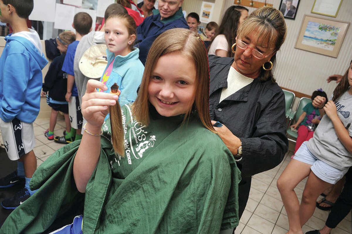 Hour photo/Matthew Vinci 10-year-old Lily Umphred gets her hair cut Sunday at the Locks for Lyla fundraiser at Arena Hairstyling in Wilton.