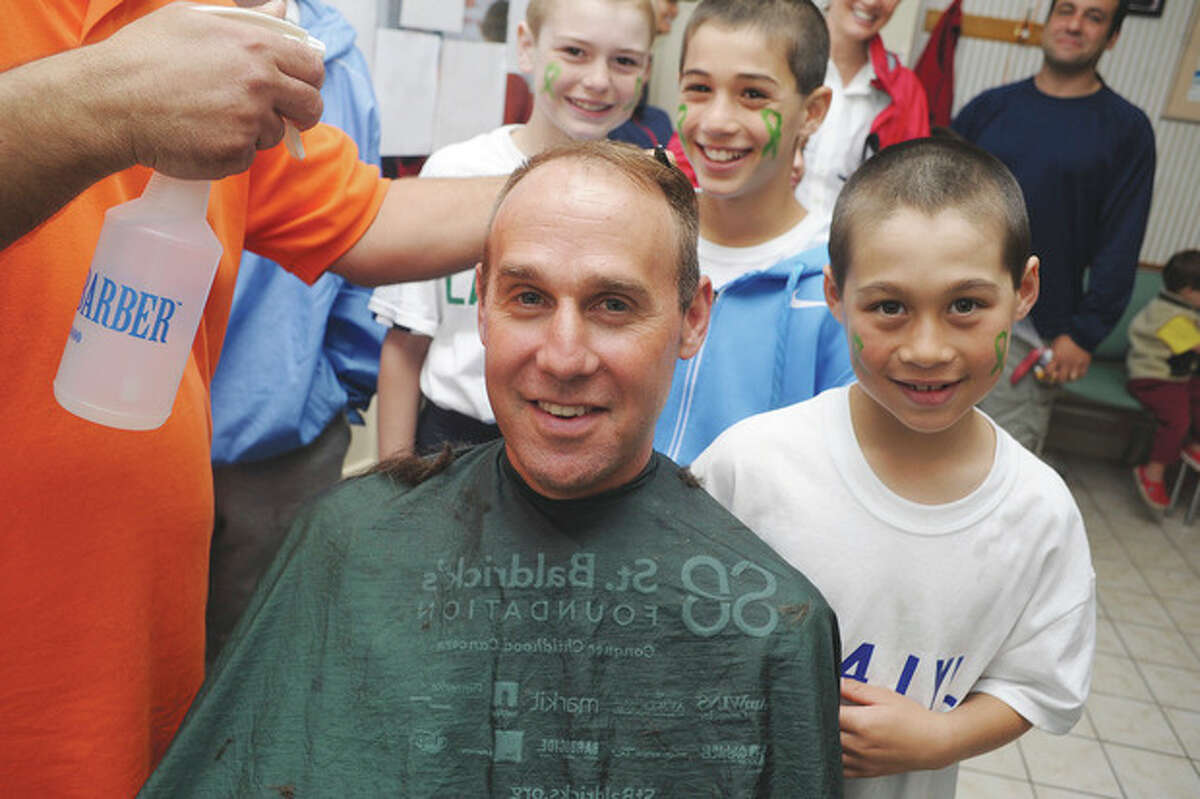 Hour photo / Matthew Vinci Sixth-grade lacrosse coach Tony Grandolfo and his team get their hair cut at the Locks for Lyla fundraiser at Arena Hairstyling in Wilton.