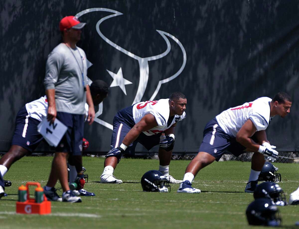 Texans lineman Christian Covington (center) stretches during Texans mini camp at NRG Stadium, Wednesday, June 15, 2016, in Houston.