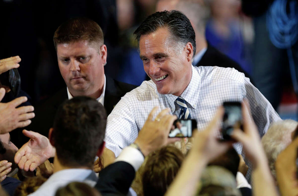 Republican presidential candidate and former Massachusetts Gov. Mitt Romney greets supporters during a campaign stop, Wednesday, Oct. 24, 2012, at the Eastern Iowa Airport in Cedar Rapids, Iowa. (AP Photo/Charlie Neibergall)