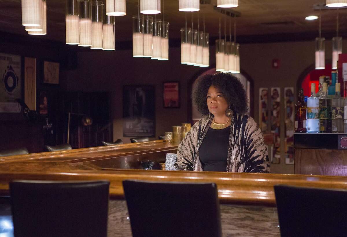 This image released by OWN shows Oprah Winfrey as Mavis McCready in a scene from the original series, "Greenleaf." The show, which premieres Tuesday at 10 p.m., explores the flawed nature of the first family of a sprawling Memphis, Tennessee, megachurch. Winfrey, who is the executive producer, plays an outspoken bar owner she calls the "high priestess" of the neighborhood. (OWN via AP)