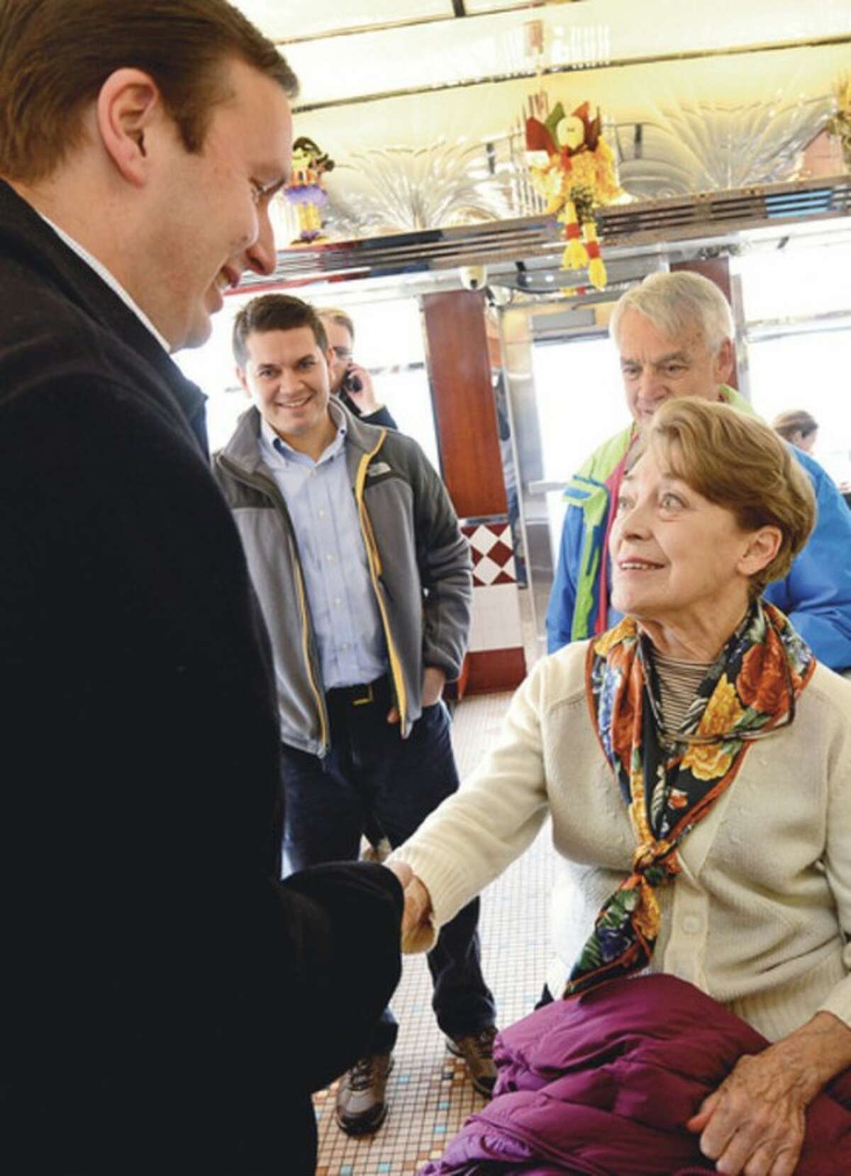 Democratic candidate for State Representative 142nd seat, Kate Tepper, greets newly elected US Senator Chris Murphy at The Post Rd Diner Thursday. Hour photo / Erik Trautmann