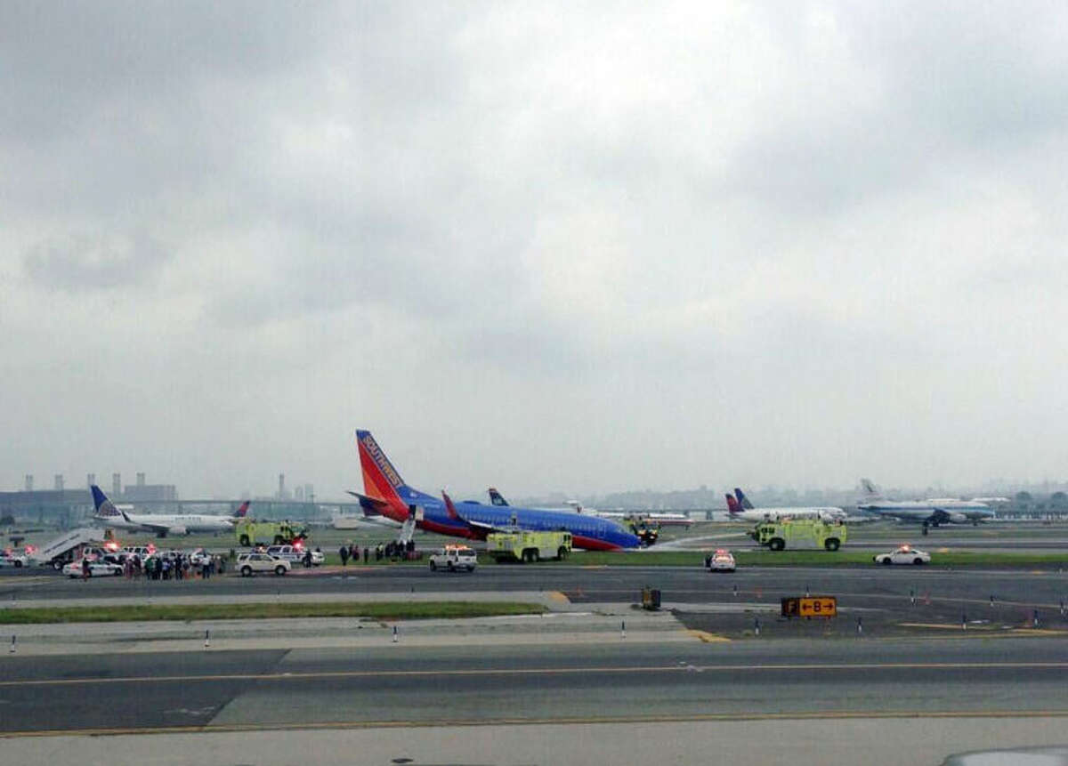 This photo provided by Bobby Abtahi, shows what officials say was a plane where the nose gear collapsed during landing at New York’s LaGuardia Airport, Monday, July 22, 2013. The Federal Aviation Administration says the plane landed safely. (AP Photo/Bobby Abtahi)