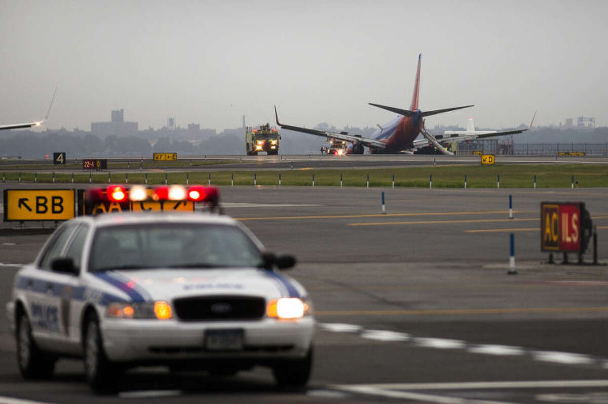 A southwest airlines plane rests on the tarmac after what officials say was a nose gear collapse during a landing at LaGuardia Airport, Monday, July 22, 2013, in New York. The Federal Aviation Administration says the plane landed safely. (AP Photo/John Minchillo)