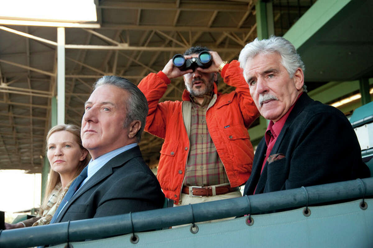 In this undated image released by HBO, from left, Joan Allen, Dustin Hoffman, John Ortiz and Dennis Farina are shown in a scene from the HBO original series "Luck." Farina died suddenly on Monday, July 22, 2013, in Scottsdale, AZriz., after suffering a blood clot in his lung. He was 69. (AP Photo/HBO, Gusmano Cesaretti, File )
