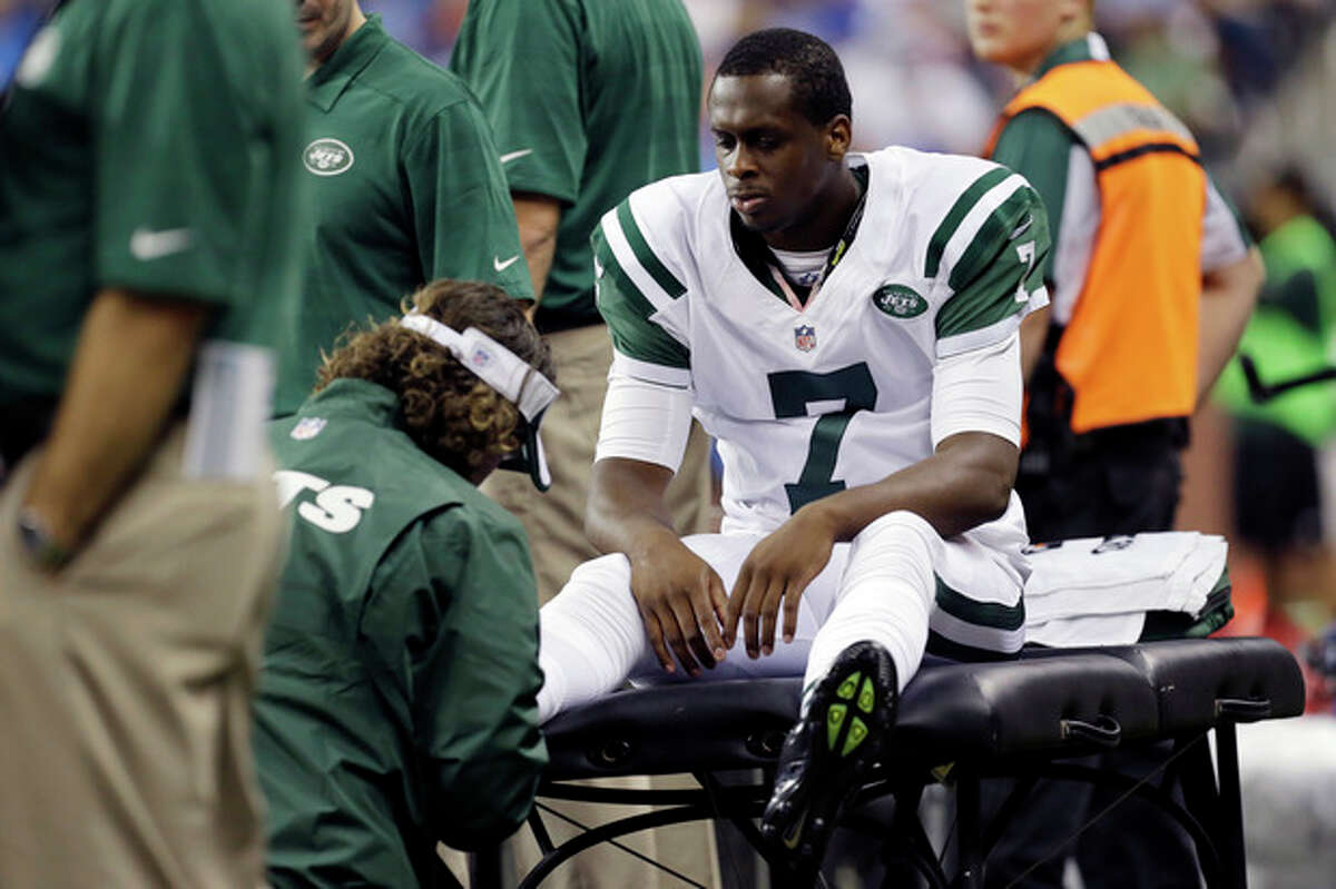 New York Jets quarterback Geno Smith (7) is examined during the third quarter of an NFL football game against the Detroit Lions at Ford Field in Detroit, Friday, Aug. 9, 2013. (AP Photo/Paul Sancya)