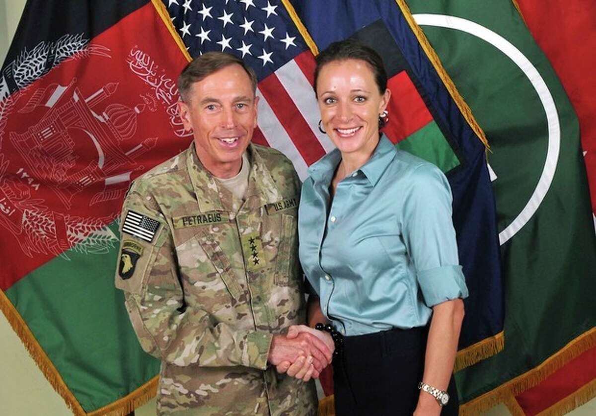 This July 13, 2011, photo made available on the International Security Assistance Force's Flickr website shows the former Commander of International Security Assistance Force and U.S. Forces-Afghanistan Gen. Davis Petraeus, left, shaking hands with Paula Broadwell, co-author of "All In: The Education of General David Petraeus."As details emerge about Petraeus' extramarital affair with his biographer, Broadwell, including a second woman who allegedly received threatening emails from the author, members of Congress say they want to know exactly when the now ex-CIA director and retired general popped up in the FBI inquiry, whether national security was compromised and why they weren't told sooner. (AP Photo/ISAF)