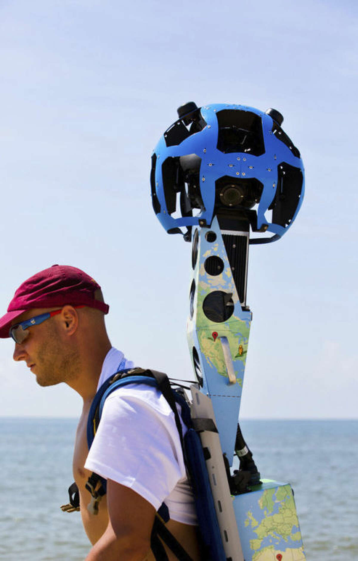 In this photo taken July 30, 2013, and made available by Visit Florida, Chris Officer carries a Google street view camera as he walks recording St. George Island beach in the Florida Panhandle. Visit Florida, the state's tourism agency, partnered with Google in the effort to map all 825 miles of Florida?’s beaches. The Florida project is the first large-scale beach mapping project. (AP Photo/Visit Florida, Colin Hackley)