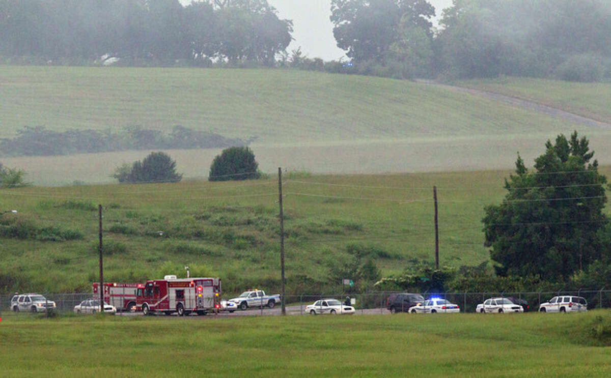 Fire crews arrive on scene of a plane crash at the Birmingham International Airport in Birmingham, Ala., on Wednesday, Aug. 14, 2013. An airport spokeswoman says the large UPS cargo plane that crashed went down in an open field just outside the airport. (AP Photo/Butch Dill)
