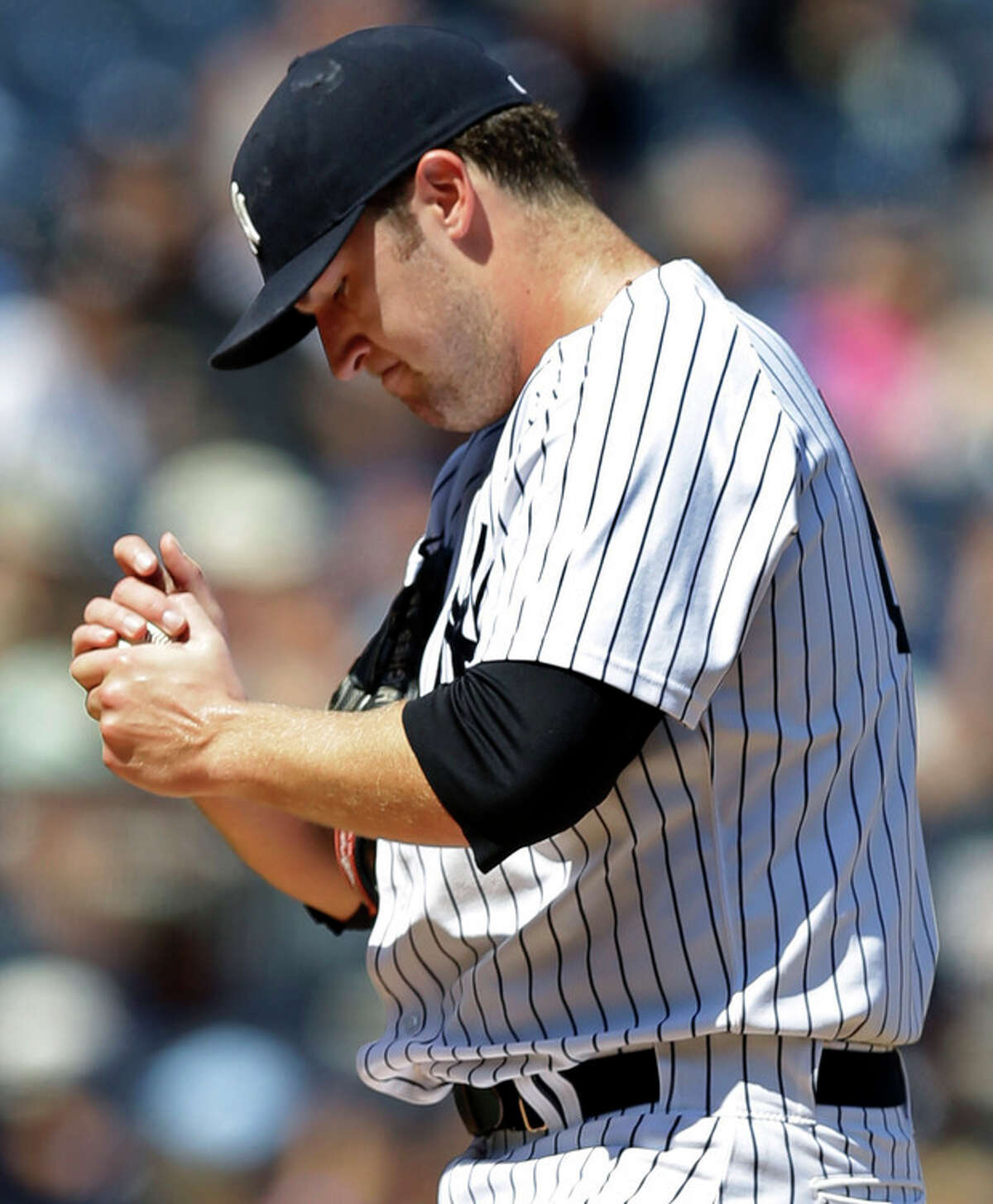 New York Yankees starting pitcher Phil Hughes reacts after allowing a fourth-inning solo home run to Los Angeles Angels' Chris Nelson in a baseball game, Thursday, Aug. 15, 2013, in New York. (AP Photo/Kathy Willens)