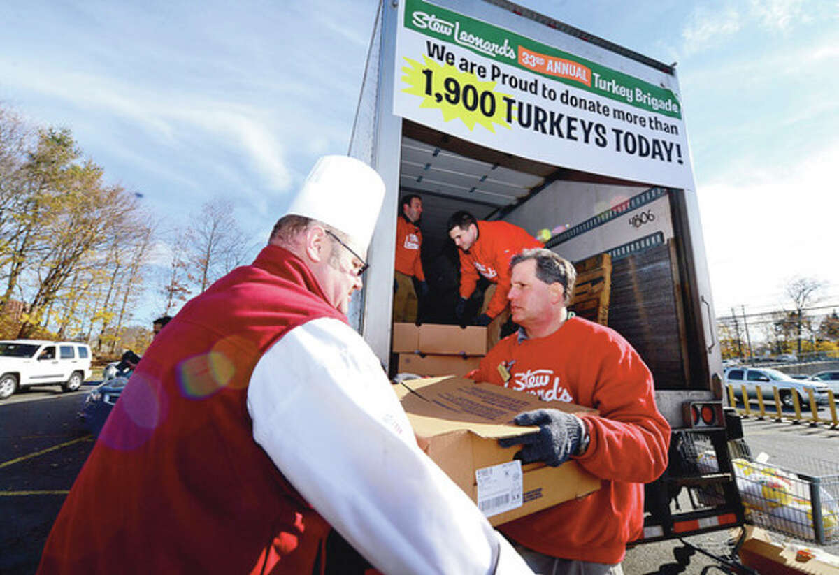 Michael Luboff, Andrew Colton and Rob Jevarjian help as Stew Leonard's 33rd Annual "Turkey Brigade" distributes 1,929 turkeys to more than 100 churches, civic groups, elderly housing and senior nutrition programs, and schools the Norwalk and other communities that Stew Leonard'ss serve to help provide Thanksgiving day meals for families in need. Hour photo / Erik Trautmann