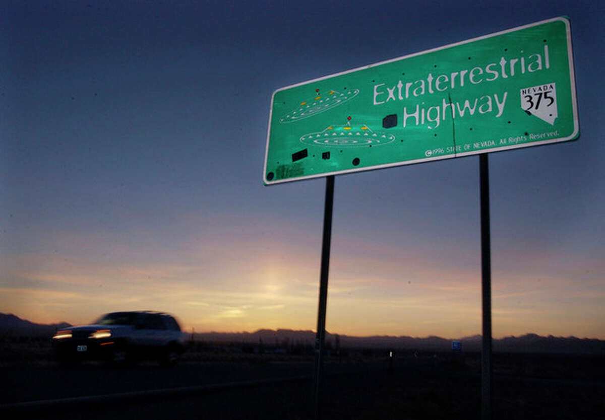 File - A car moves along the Extraterrestrial Highway near Rachel, Nevada, in this Wednesday, April 10, 2002 file photo. The CIA is acknowledging the existence of Area 51 in newly declassified documents. George Washington University's National Security Archive obtained a CIA history of the U-2 spy plane program through a public records request and released it Thursday Aug. 15, 2013. (AP Laura Rauch, File)
