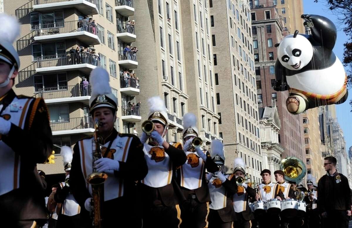 The Kung Fu Panda balloon, right, participates in the 86th annual Macy's Thanksgiving Day Parade,Thursday, Nov 22, 2012, in New York. (AP Photo/ Louis Lanzano)
