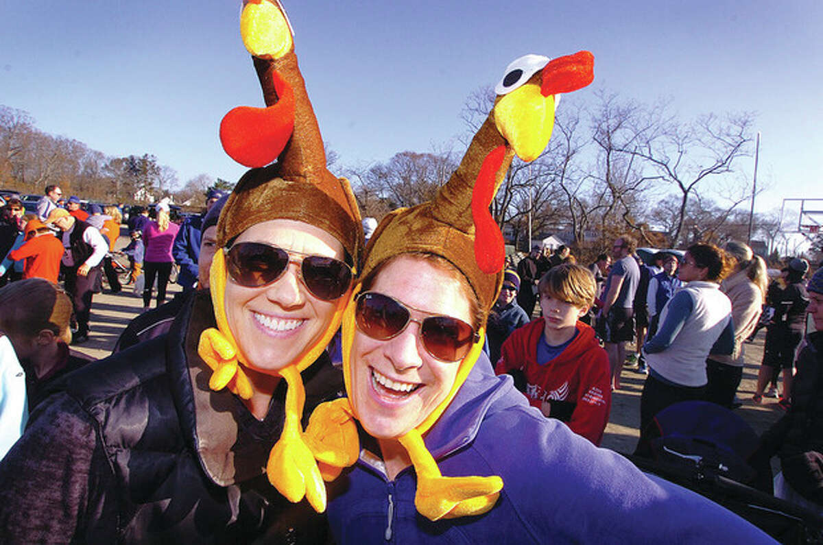 Hour photo / Alex von Kleydorff From left, Melissa Wanger and Heather Raker share similar taste in hats, at least during one day of the year, for Rowayton's Turkey Trot on Thanksgiving.