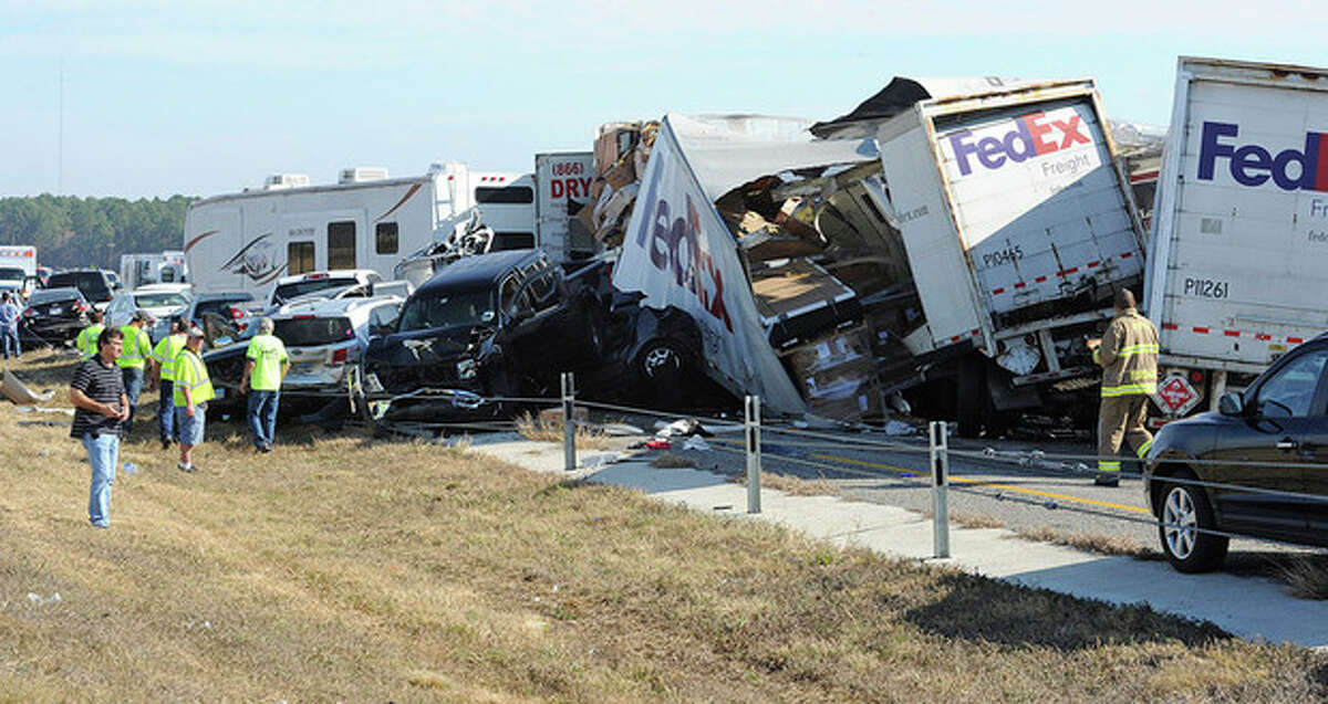 Cars and Trucks are piled on Interstate 10 in Southeast Texas Thursday Nov. 22, 2012. The Texas Department of Public Safety says at least 35 people have been injured in a more than 50-vehicle pileup. (AP Photo/The Beaumont Enterprise, Guiseppe Barranco)