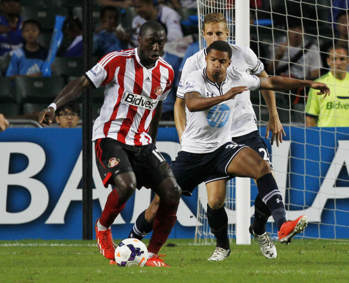 Jozy Altidore of Sunderland, left, controls the ball during the match against Tottenham Hotspur at the Barclays Asia Trophy Wednesday, July 24, 2013. (AP Photo/Kin Cheung)
