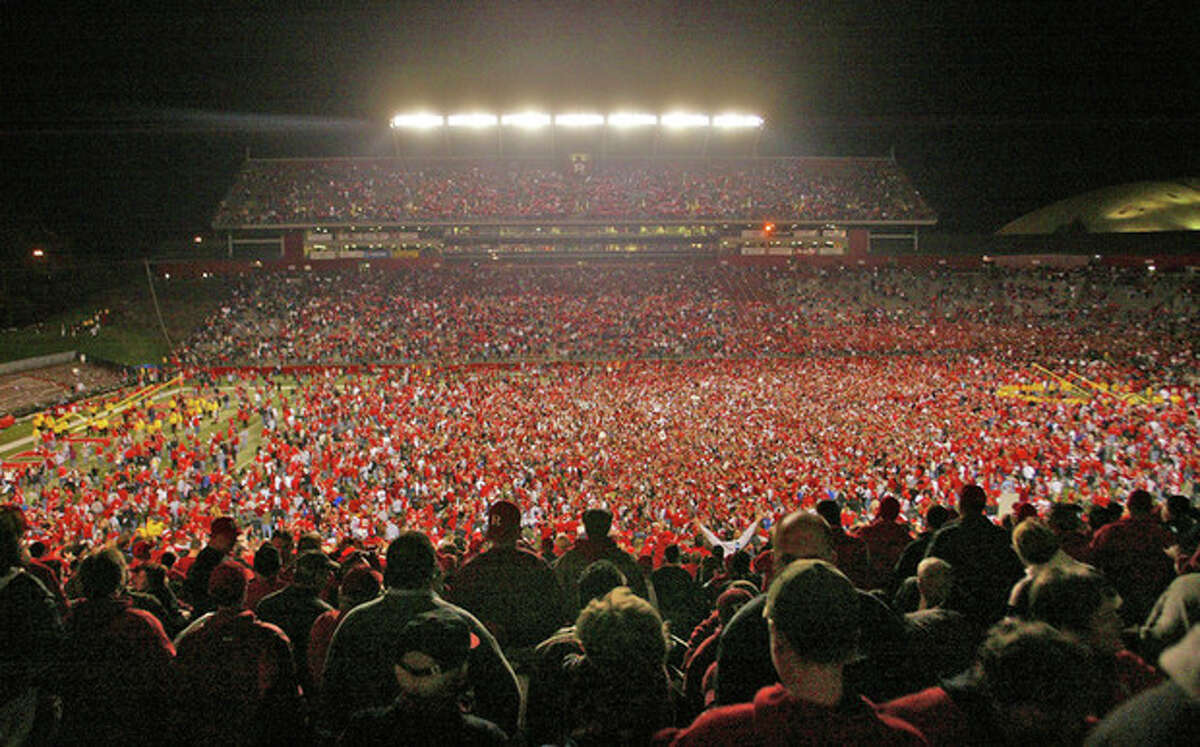 FILE - This Nov. 9, 2006 file photo shows fans on the field after Rutgers defeated Louisville 28-25 in a college football game in Piscataway, N.J. Rutgers is announcing that it will join the Big Ten at an afternoon news conference Tuesday, Nov. 20, 2012, on its campus in Piscataway, N.J. (AP Photo/Tim Larsen)