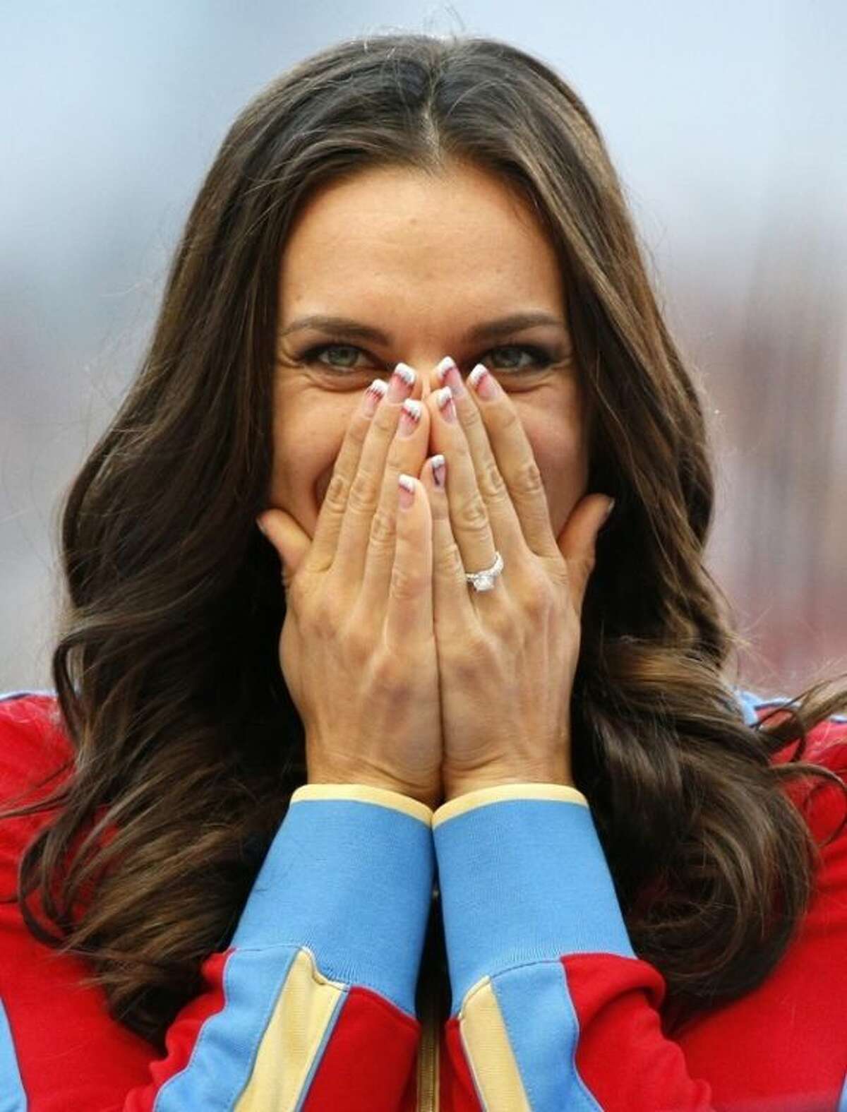 Russia's Yelena Isinbayeva reacts as she stands on the podium after receiving the gold medal in the women's pole vault during the medal ceremony at the World Athletics Championships in the Luzhniki stadium in Moscow, Russia, Thursday, Aug. 15, 2013. (AP Photo/Alexander Zemlianichenko)