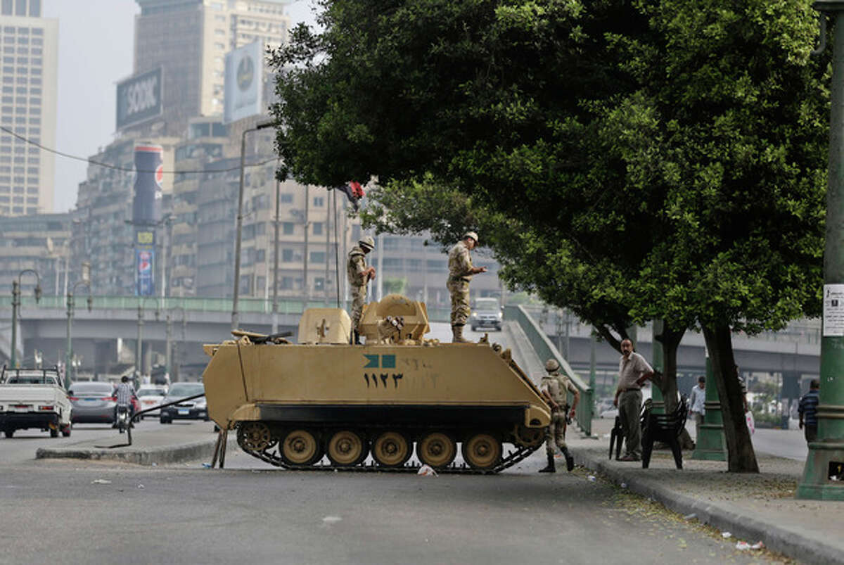 Egyptian Army soldiers take their positions on top of their armored vehicles while guarding an entrance to Tahrir Square, in Cairo, Egypt, Friday, Aug. 16, 2013. Egypt is bracing for more violence after the Muslim Brotherhood called for nationwide marches after Friday prayers and a "day of rage" to denounce this week's unprecedented bloodshed in the security forces' assault on the supporters of the country's ousted Islamist president that left more than 600 dead. (AP Photo/Hassan Ammar)