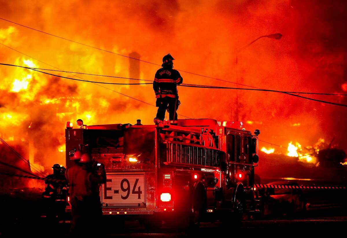 A Daly City firefighter stands atop an engine to survey the fire on Claremont Drive in San Bruno, where a suspected explosion in a gas line ignited the area.A Daly City firefighter stands atop an engine to survey the carnage of the gas pipeline explosion.