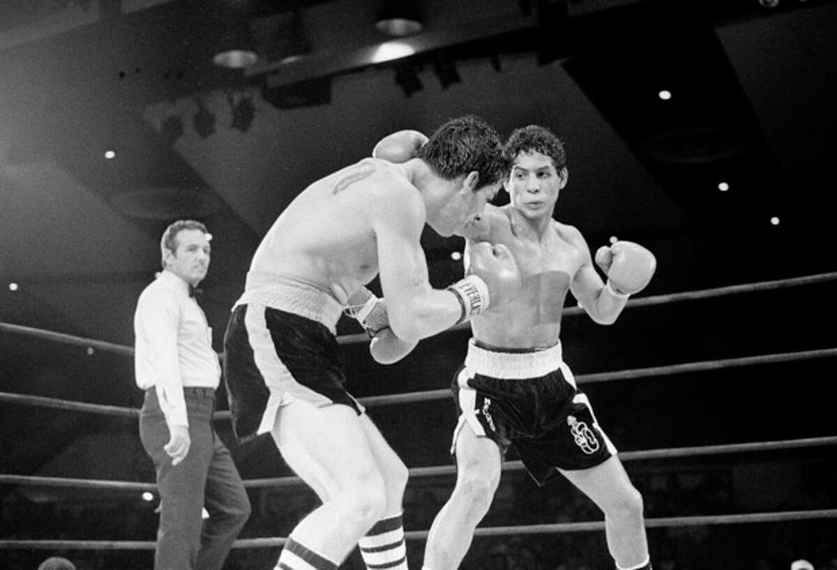 FILE - In this July 11, 1982 file photo, Luis Loy Jr., left, ducks under a blow by Hector Camacho early in a scheduled 10-round junior lightweight boxing bout at Felt Forum in New York. Hector "Macho" Camacho, a boxer known for skill and flamboyance in the ring, as well as for a messy personal life and run-ins with the police, has died, Saturday, Nov. 24, 2012, after being taken off life support. He was 50. (AP Photo/Elias, File)