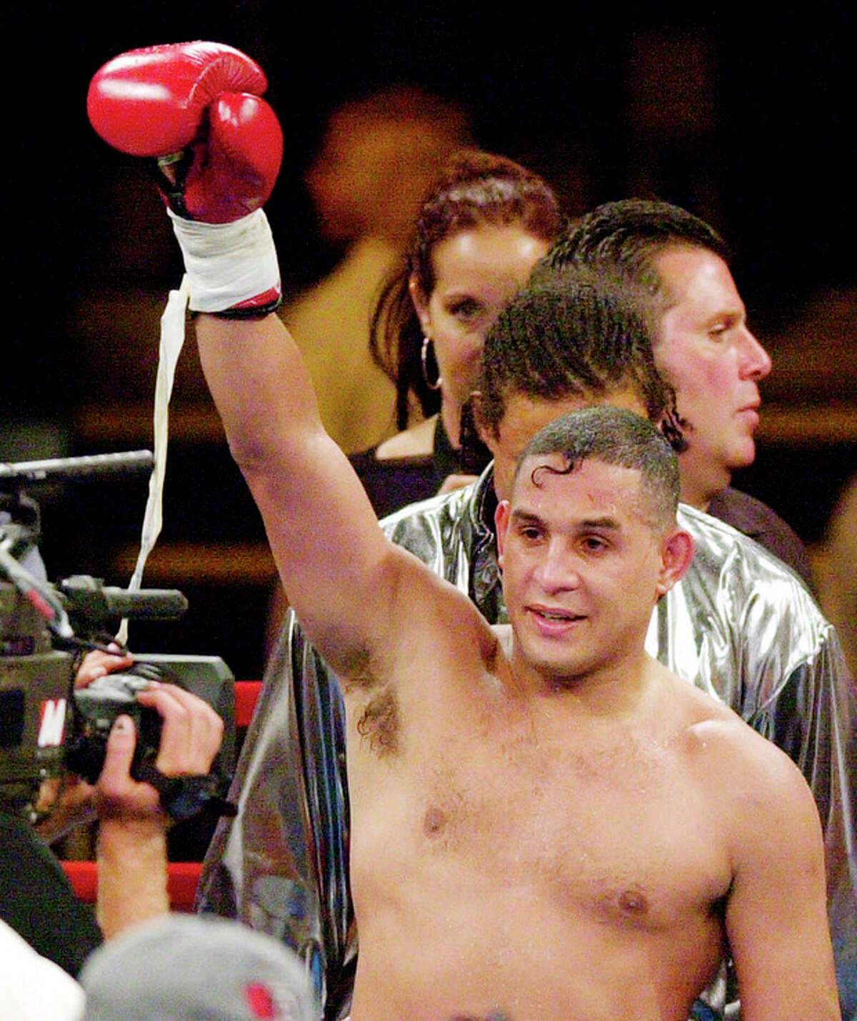 FILE - In this July 14, 2001 file photo, boxing champ Hector "Macho" Camacho celebrates after defeating Roberto Duran in their super middleweight National Boxing Association championship fight in Denver. Camacho, a boxer known for skill and flamboyance in the ring, as well as for a messy personal life and run-ins with the police, has died, Saturday, Nov. 24, 2012, after being taken off life support. He was 50. (AP Photo/Ed Andrieski, File)