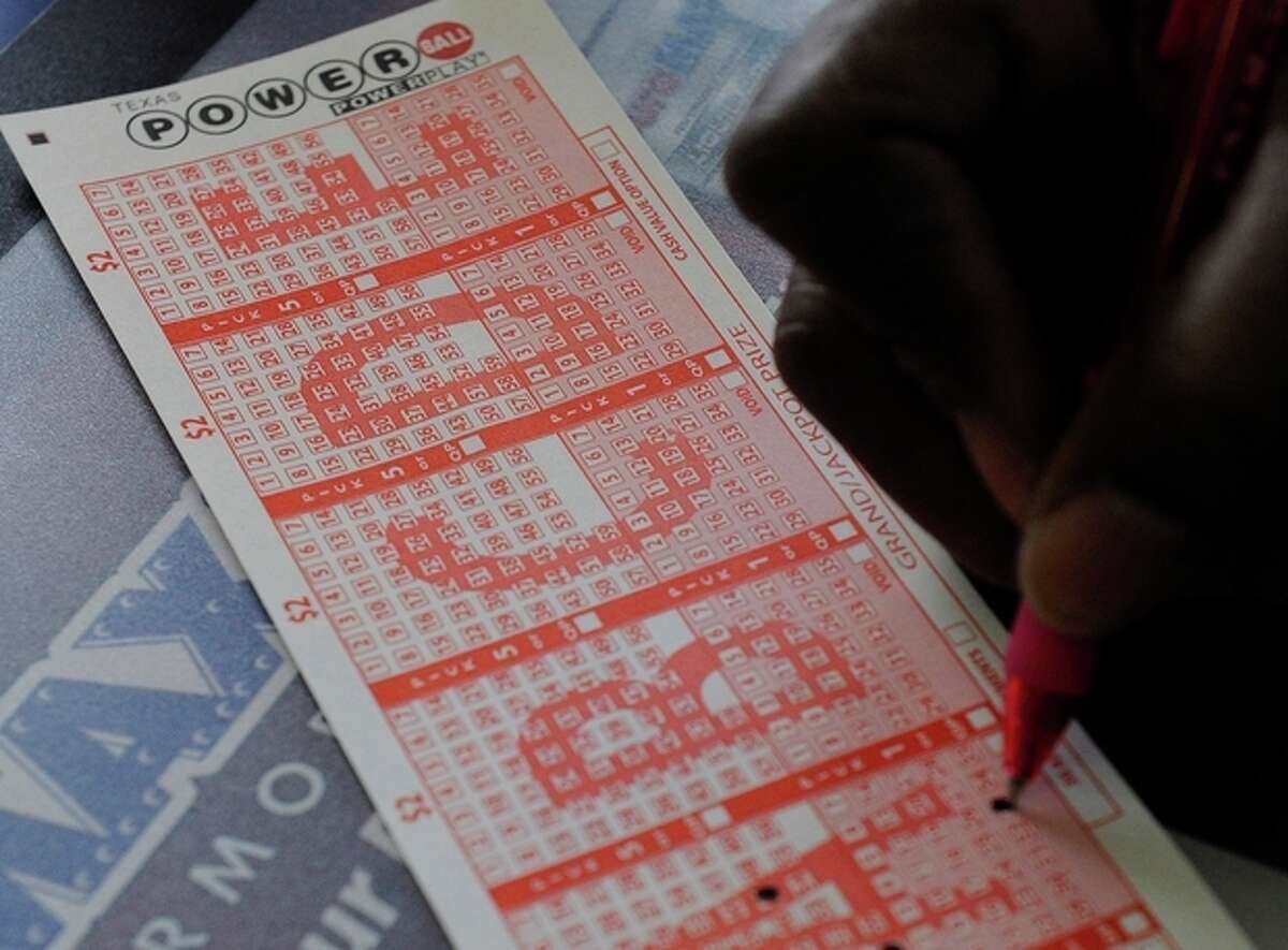 A customer fills in his numbers on a Powerball ticket for a chance to win the $450,000 jackpot Monday, Nov. 26, 2012, in Houston for a chance to win the $450,000 jackpot. (AP Photo/Pat Sullivan)