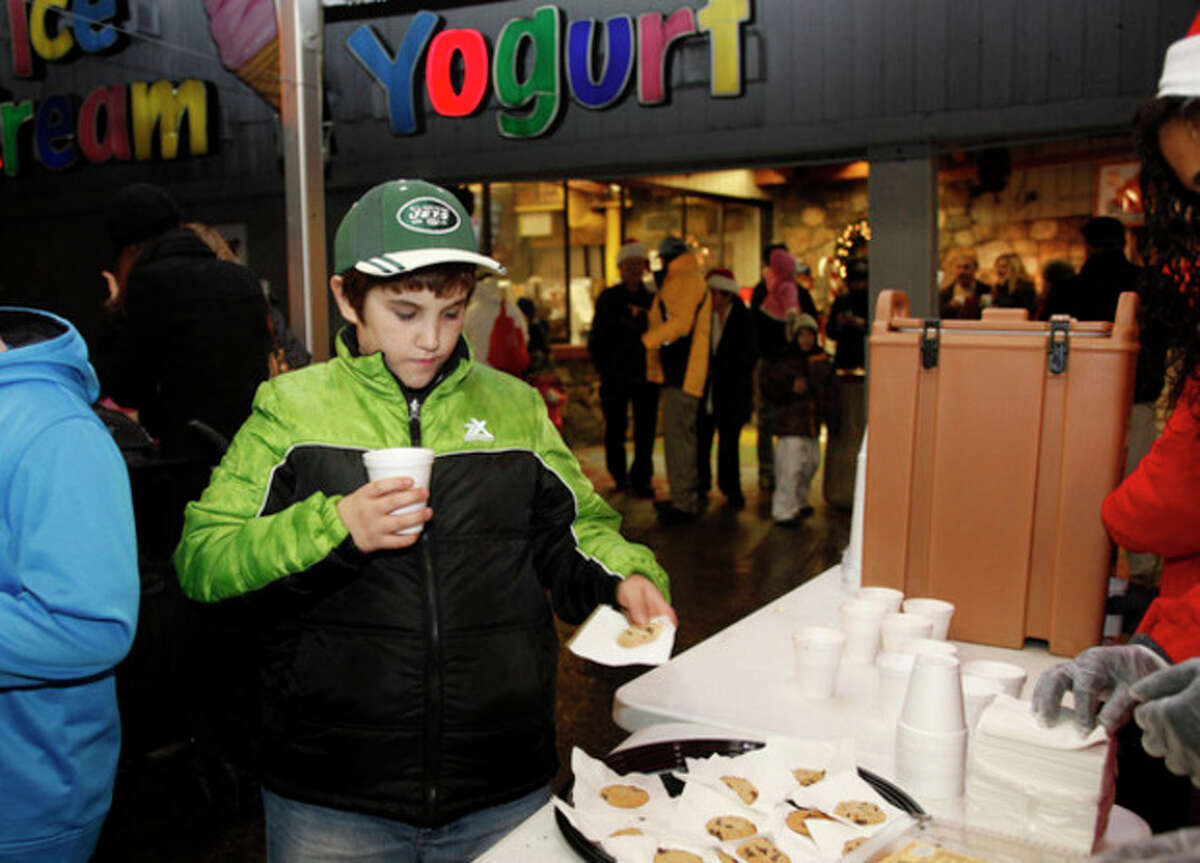 Brien McMahon, 10, grabs some hot chocolate and a cookie during Stew Leonard's annual tree lighting Tuesday evening. Hour Photo / Danielle Robinson