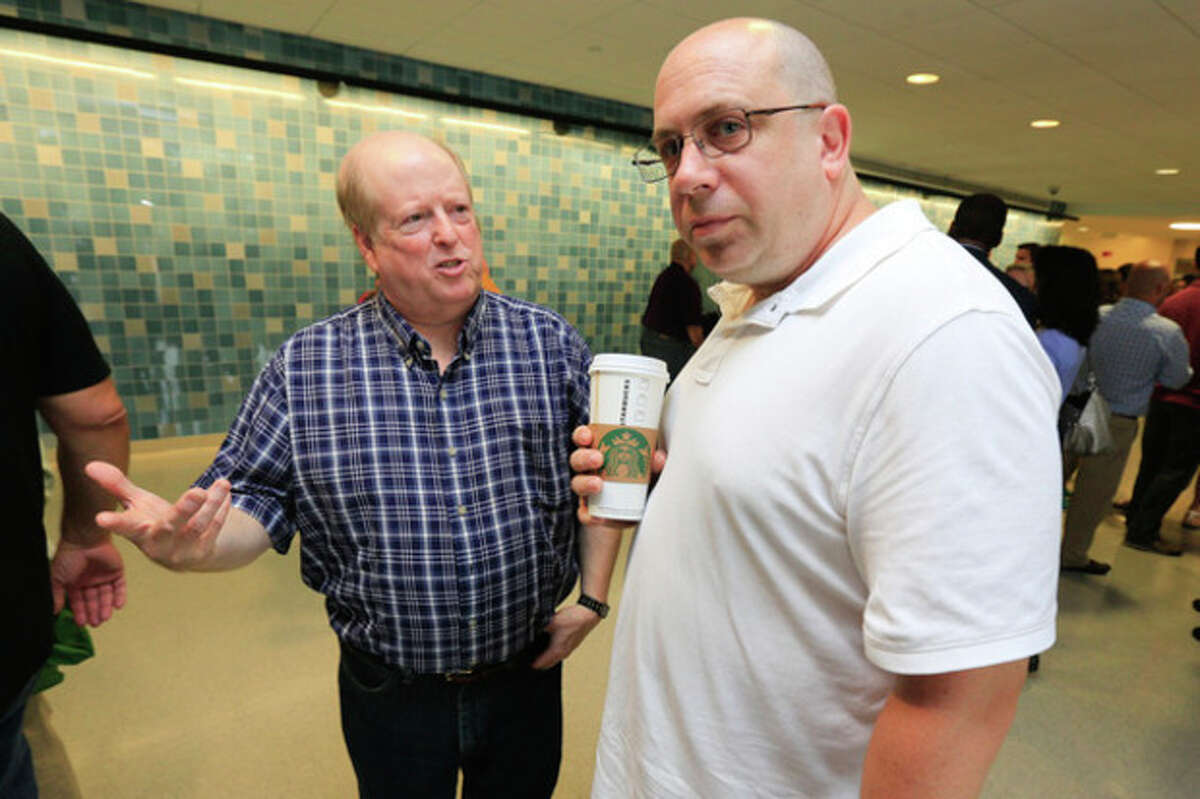 Schools Psychologists Dr. Robert Johnson and Dr. Alan Vaglivelo chat beofre the teachers convocation Monday monrning at Brien McMahon. Hour Photo / Chris Palermo