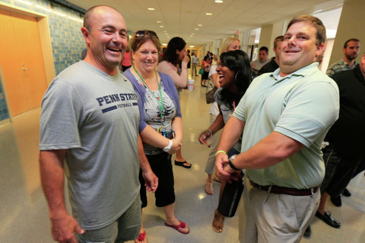 West Rocks Middle School teachers Pat Testa and Kevin Lippert chat before the teachers convocation Monday monrning at Brien McMahon. Hour Photo / Chris Palermo