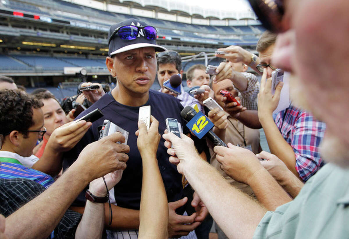 New York Yankees' Alex Rodriguez addresses a media swarm before a baseball game against the Toronto Blue Jays at Yankee Stadium, Wednesday, Aug. 21, 2013, in New York. (AP Photo/Kathy Willens)